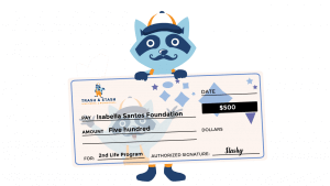Stashy holding an oversized check for Isabella Santos Foundation