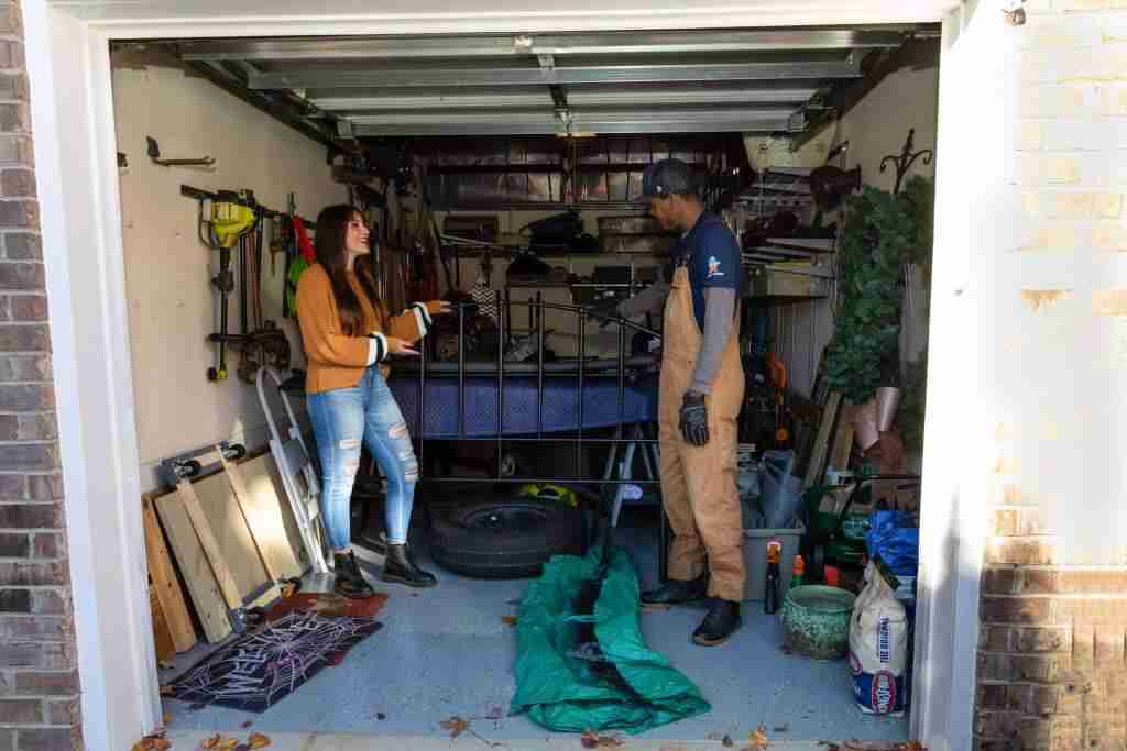 trash and stash in the garage with customer looking at items to store